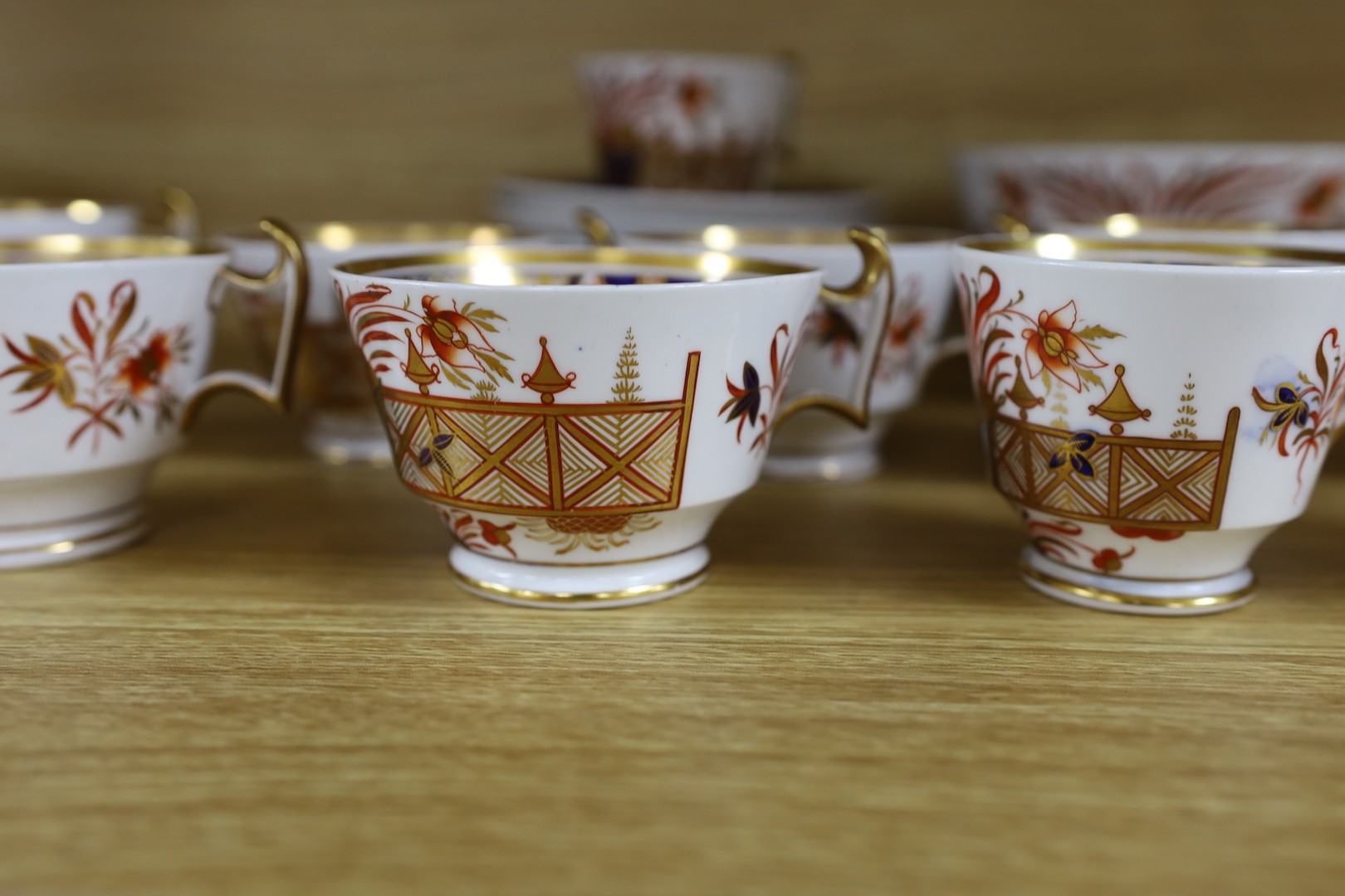 A Spode part Imari tea service consisting of six London shape tea cups, coffee cups and saucers, two graduated saucer dishes and a bowl pattern 1495